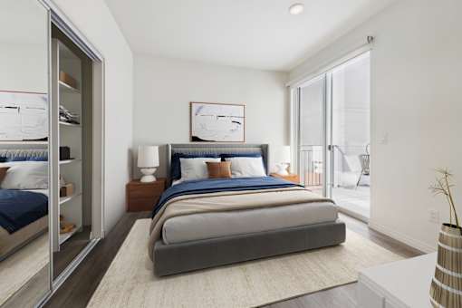 A bedroom with a large bed and a sliding glass door.