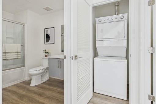 A white toilet and sink in a bathroom.