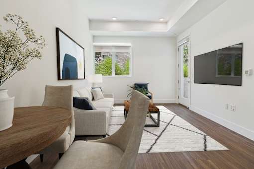 A modern living room with a wooden table and a large painting on the wall.