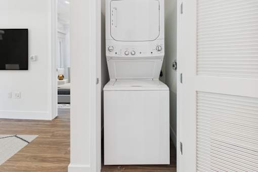 A white washing machine in a small room.