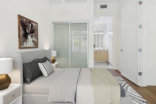 A bedroom with a bed, nightstand, and a painting on the wall.