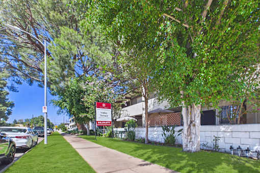 A street view of a residential area with a sign for Valley Terrace.