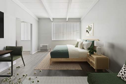 A bedroom with a bed, nightstand, and chair.