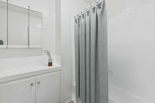 A white bathroom with a glass shower door.