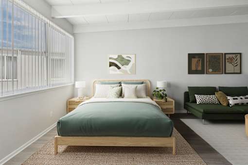 A bedroom with a bed, nightstands, and a couch.