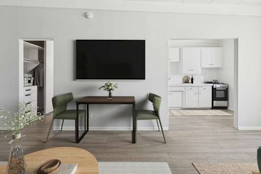 A modern living room with a flat screen TV mounted on the wall.