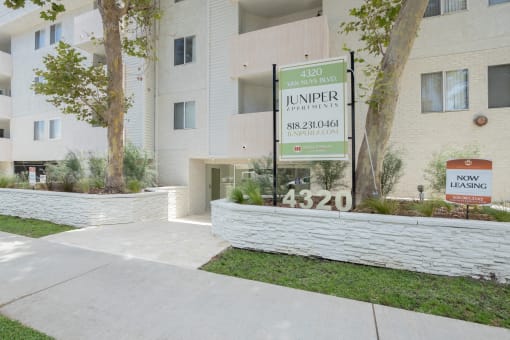 the entrance to a apartment building with a sign for the junior apartments