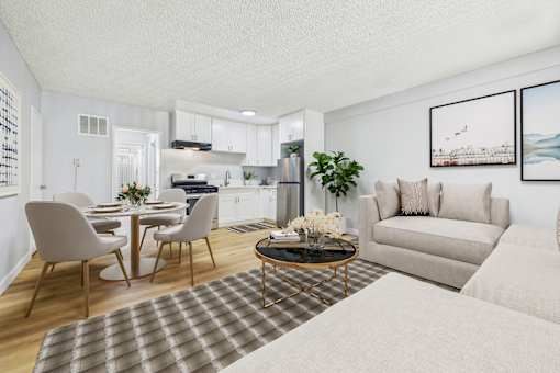 A modern living room with a dining table and chairs.