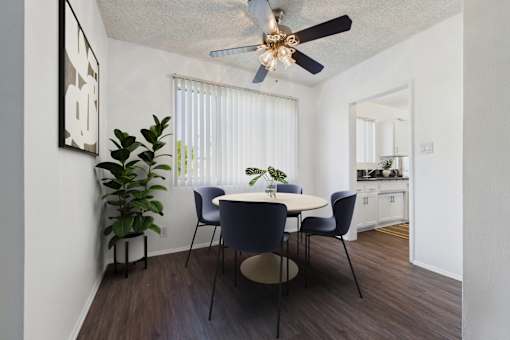 A dining room with a table and chairs.