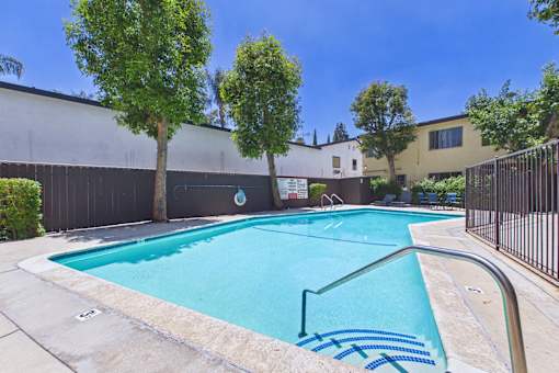 A small pool with a metal fence around it.