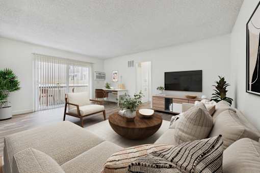 A living room with a couch, a chair, a coffee table, and a television.