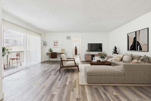 A living room with a couch, chair, and television.