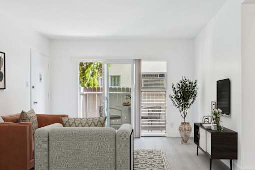 A living room with a grey couch and a brown armchair.