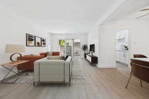 A living room with a grey sofa and a brown armchair.