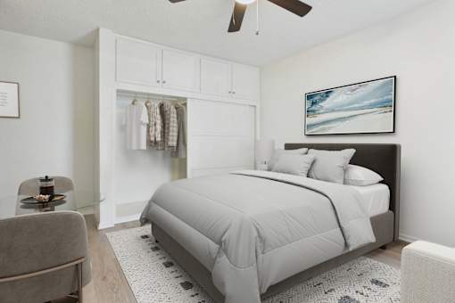 A bedroom with a large bed and a ceiling fan.