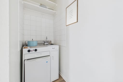 A white kitchen with a dishwasher and a stove top.
