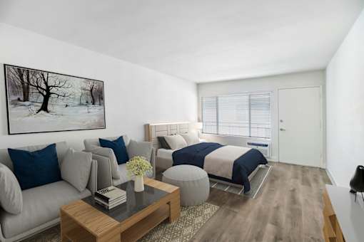 a bedroom with a bed and a couch and a table