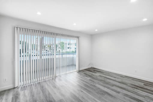 the living room has a sliding glass door to the patio