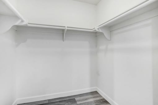an empty white room with white walls and a wood floor