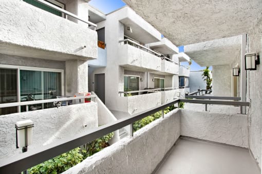a view of a building with white concrete walls and balconies