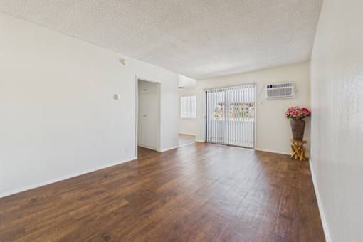 A room with wooden floors and white walls.