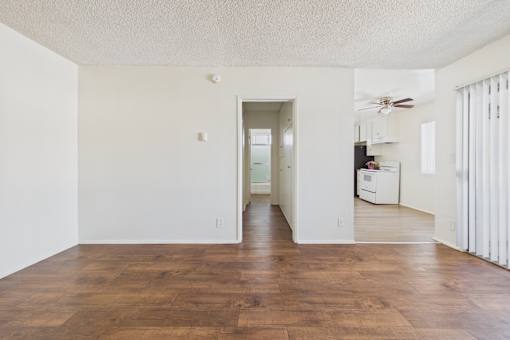 A room with wooden floors and white walls.