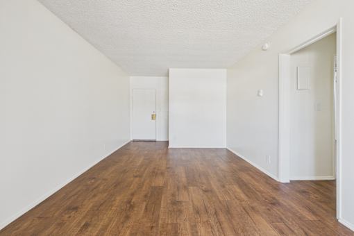 A room with wooden floors and white walls.