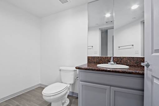 A white toilet sits next to a sink in a bathroom.