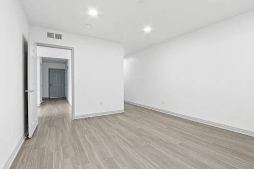 A room with a wooden floor and white walls.