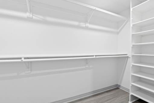 Empty white shelves in a room.