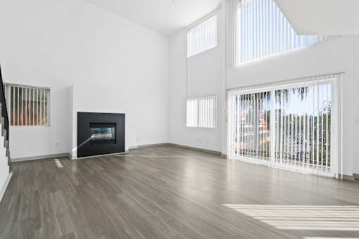 A living room with a fireplace and a television.
