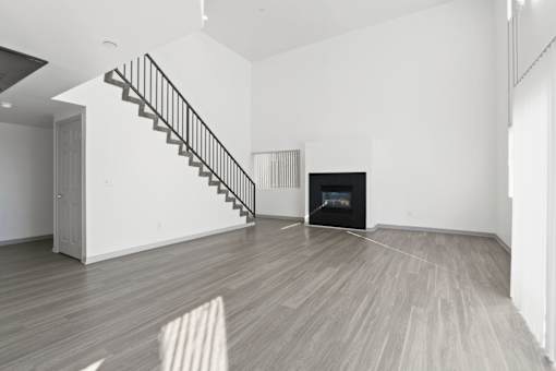 A room with a staircase and a fireplace.