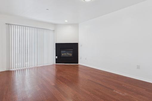 A room with a fireplace and wooden floors.