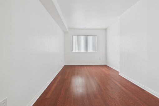 A room with wooden floors and white walls.