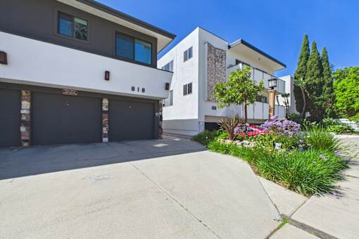 A modern two-story house with a garage and a driveway.
