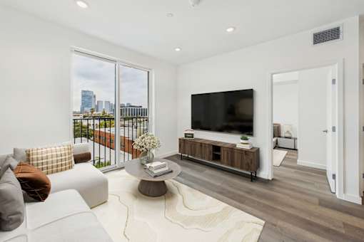 A modern living room with a large window overlooking the city.