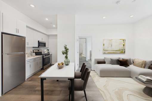 A modern kitchen with a dining table and chairs.