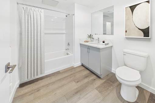 A white toilet sits next to a sink in a bathroom.