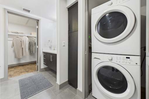 A row of washing machines in a laundry room.