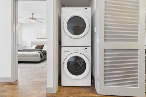A white washing machine and dryer in a laundry room.