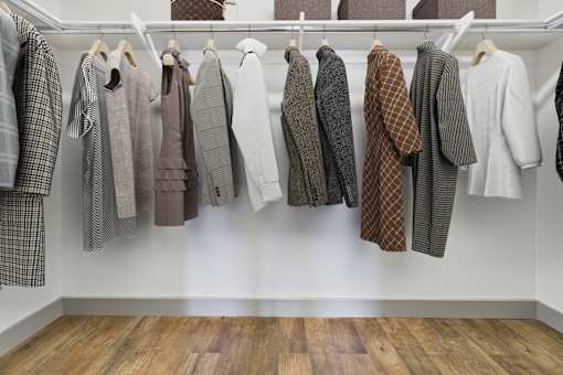 A row of clothes hanging on a rack.