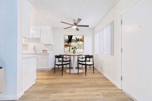 A kitchen with a table and chairs in the middle of the room.