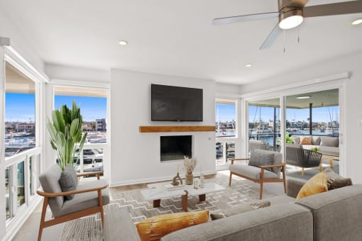 a living room with a couch and chairs and a television