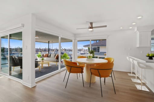 an open dining room with a table and chairs and a view of the harbor