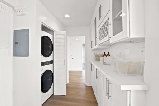 a white laundry room with a washer and a dryer