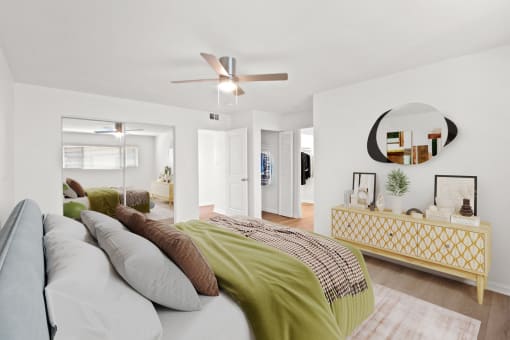 a bedroom with a large bed and a ceiling fan