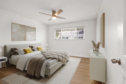 a bedroom with a bed and a ceiling fan