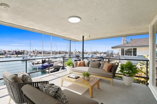 a living room with a balcony overlooking a marina