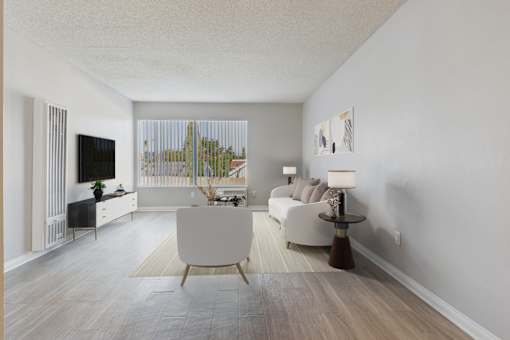 A living room with a white couch, a white chair, a white coffee table, and a white wall.