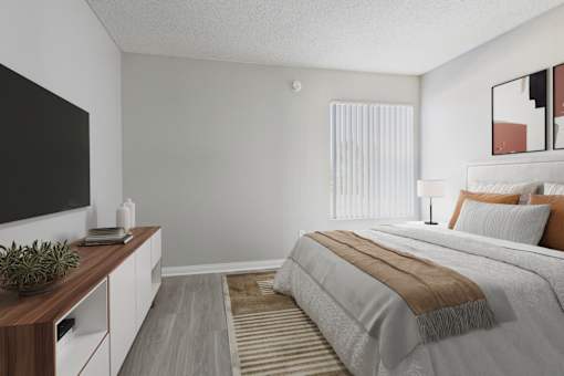 A bedroom with a large bed and a television on the wall.